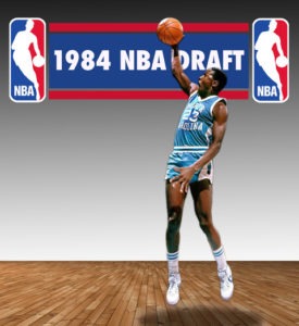 Feature Image of Michael Jordan with basketball in front of a 1984 NBA Draft banner